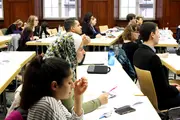 Impressions of attendees sitting and listening to the speakers.