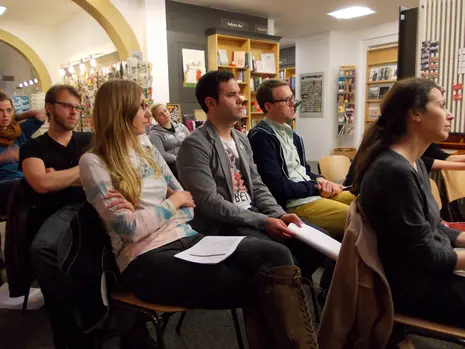 Photo of Joshua Weiner giving his reading and attendees listening to him.