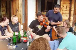 Photo of the participants of the seminar enjoying their evening playing music and having dinner together.