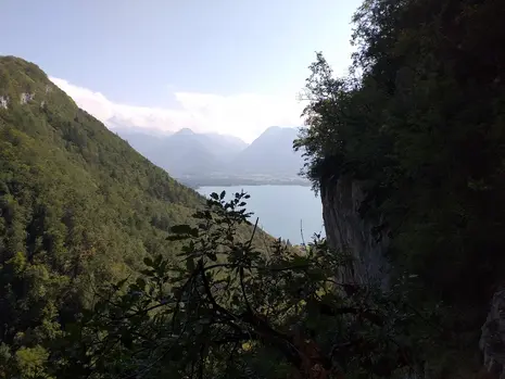 Photo of the mountainscape with a lake in the foreground.